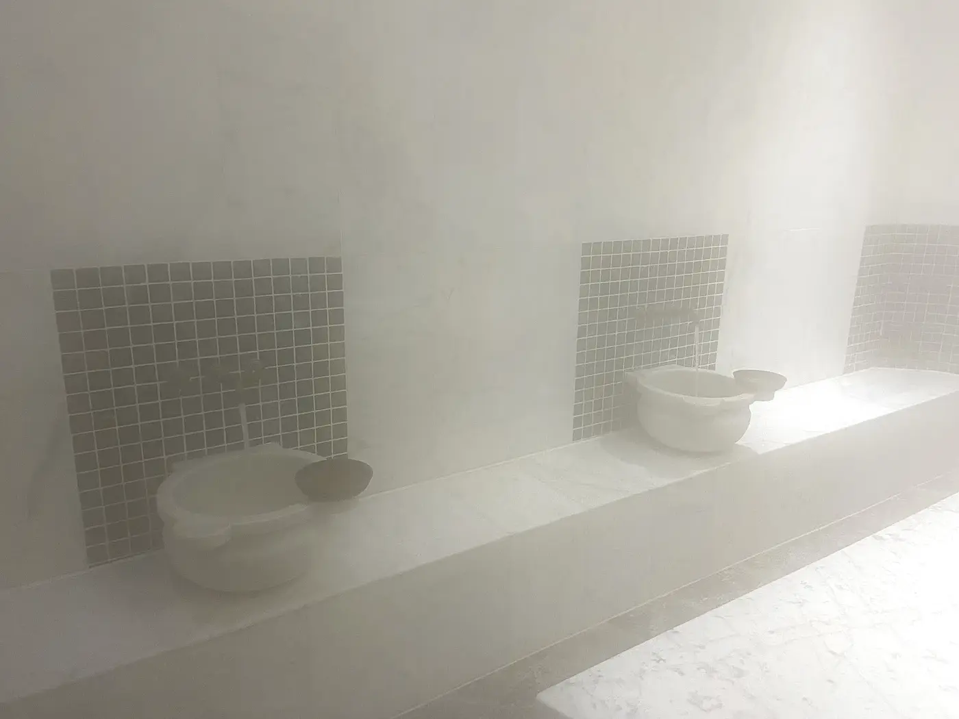 Steam-filled marble hammam with kurna basins at Turkuaz Turkish Baths & Spa, Dunfermline